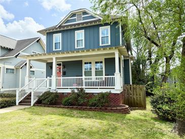 Charming two-story home with a welcoming front porch and nicely landscaped front yard at 505 State St, Charlotte, NC 28208