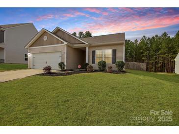 Charming single-Gathering home featuring a well-maintained lawn and an attached garage at 8606 Highgate Dr, Charlotte, NC 28215