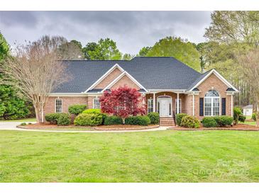 Charming brick home featuring a well-manicured lawn, decorative landscaping, and a classic architectural design at 111 Sterling Dr, York, SC 29745