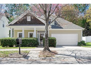 Charming single-Gathering home featuring a well-manicured lawn, attached garage, and inviting front porch at 19221 Coachmans Trce, Cornelius, NC 28031