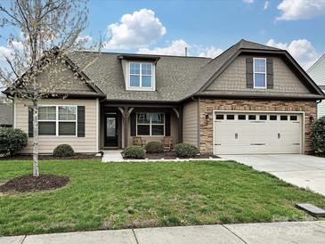 Attractive home showcasing a well-kept lawn, attached two-car garage, and stylish architectural details at 4425 Marlay Park, Indian Trail, NC 28079