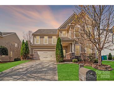 Charming two-story home featuring a well-manicured lawn and a two-car garage, nestled in a suburban neighborhood at 1504 Ridge Haven Rd, Waxhaw, NC 28173