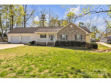 Charming single-story home with a brick facade, attached two-car garage, and well-maintained front yard at 1584 Beverly Ln, Lincolnton, NC 28092