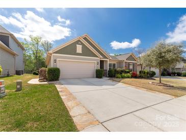 Charming single-story home featuring a two-car garage, manicured lawn, and well-maintained landscaping at 2035 Palace Way, Indian Land, SC 29707