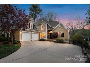 Inviting two-story home featuring a two-car garage, manicured landscaping, and elegant stone accents at 2228 Metcalf Dr, Sherrills Ford, NC 28673