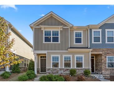 Charming two-story townhome with manicured landscaping and stone accents at 423 Wescott St # 73, Indian Trail, NC 28079