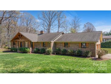 Charming brick home with a well-maintained lawn and inviting front porch at 8194 Mallard Rd, Denver, NC 28037