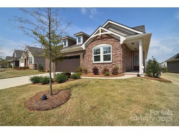 Charming brick home with well-manicured lawn and mature landscaping at 9413 Liberty Hill Dr, Mint Hill, NC 28227