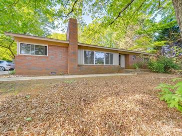 Charming brick home featuring a classic architectural design and lush green surroundings at 1881 Sharonwood Ln, Rock Hill, SC 29732