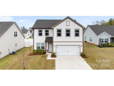Charming two-story home featuring a two-car garage and nicely manicured lawn at 1976 Ethan Ln, Stanfield, NC 28163