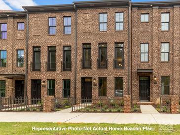 Beautiful brick townhome with charming entryways and well-maintained landscaping at 212 Gilead Rd, Huntersville, NC 28078