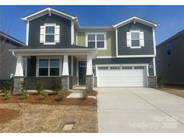 Charming two-story home featuring a two-car garage and inviting front porch at 2624 Tillman St, Monroe, NC 28112