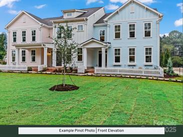 Charming townhomes featuring colorful exteriors, covered entrances, and a well-manicured lawn with white picket fences at 280 Gilead Rd, Huntersville, NC 28078