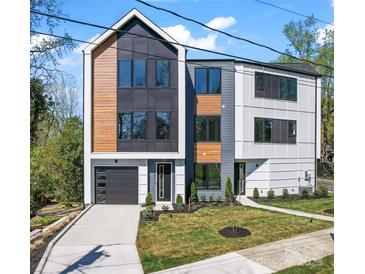 Modern home featuring mixed siding, a driveway, and manicured front yard at 3433 Byrnes St, Charlotte, NC 28205