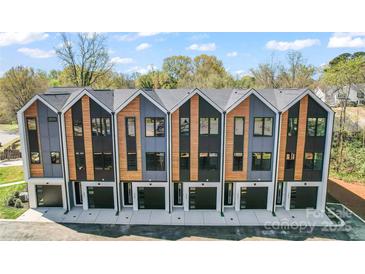 A row of modern townhouses showcasing unique architectural design and attached garages at 3441 Byrnes St, Charlotte, NC 28205