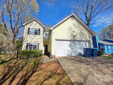 Charming two-story home with a two-car garage, classic design, and manicured front yard at 5416 River Falls Dr, Charlotte, NC 28215