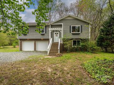 Charming two-story home with a two-car garage and inviting front porch at 5601 Indian Brook Dr, Matthews, NC 28104