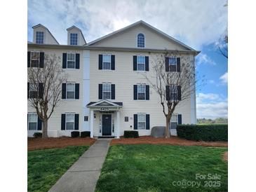 Inviting exterior of building with lush lawn, landscaping, and classic architectural details at 6423 Town Hall Pl, Harrisburg, NC 28075