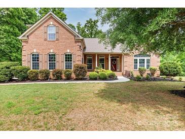 Charming brick home features a well-manicured front yard and a welcoming entrance at 9506 Minnie Lemmond Ln # 170, Mint Hill, NC 28227