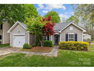 Charming single-story home with a manicured front yard and lovely landscaping at 12804 Lismorre Castle Ct, Charlotte, NC 28273
