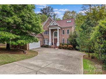 Elegant brick home features classic architectural details and a well-manicured front lawn at 16614 Ruby Hill Pl, Charlotte, NC 28278