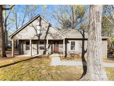 Charming single-story home with covered porch and well-maintained lawn in a peaceful neighborhood at 2124 Marquesas Ave, Tega Cay, SC 29708