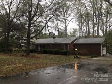 Charming brick home with a well-maintained lawn and lush landscaping at 235 John Rainey Rd, Salisbury, NC 28147