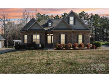 Charming brick home featuring a manicured lawn and mature landscaping at 304 Wintergreen Ct, Kings Mountain, NC 28086