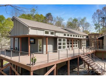Stunning home exterior featuring a spacious deck and a seamless blend of wood and modern design elements at 3249 Ivey Creek Rd, Maiden, NC 28650