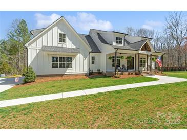 Charming white farmhouse-style home with a welcoming front porch and well-manicured lawn at 722 Clegg Farm Dr, York, SC 29745