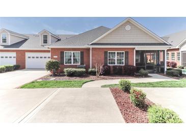 Inviting brick home featuring manicured landscaping and an attached two-car garage at 8518 Christalina Ln, Denver, NC 28037