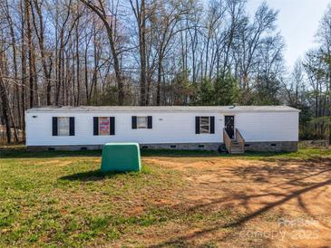 A cozy single-story home boasts a minimalist design and a peaceful setting at 1076 Percy Ln, Rockwell, NC 28138