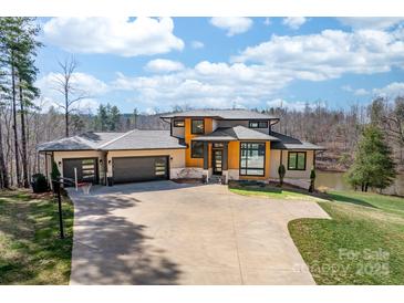 Stunning modern home with three-car garage, beautiful landscaping, and a private driveway at 233 Conifer Way, Shelby, NC 28150