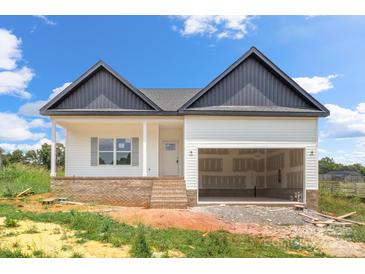 New construction home with white siding, brick foundation, and a two-car garage in a rural setting at 2508 Rock Dam Rd, Lincolnton, NC 28092