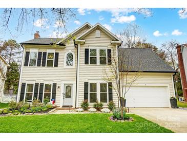 Charming two-story home featuring a well-manicured lawn, black shutters, and an attached two-car garage at 2510 Bricker Dr, Charlotte, NC 28273