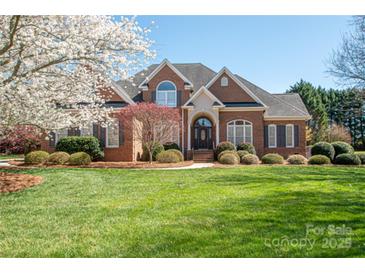 Charming two-story brick home with manicured lawn and mature landscaping, perfect for suburban living at 3071 Ancestry Cir, Matthews, NC 28104