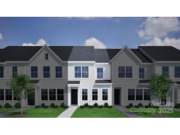 Newly constructed townhomes with well manicured lawn, dark roof and black doors at 5111 Orchardview Way # 25, Charlotte, NC 28216