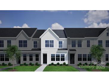 Charming townhome featuring a modern facade, manicured lawn, and inviting entrance at 5115 Orchardview Way # 24, Charlotte, NC 28216