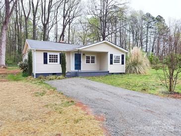 Charming single story home with black shutters and a gravel driveway at 512 Hall St, Salisbury, NC 28144