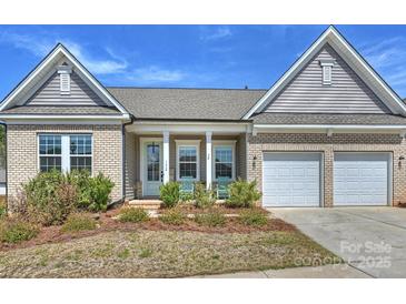 Charming brick home featuring a two-car garage, well-kept landscaping, and a welcoming front porch at 152 Amerson Dr, Rock Hill, SC 29730