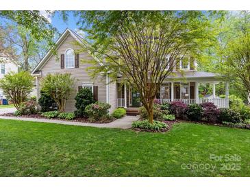 Charming two-story home with beautifully landscaped front yard and welcoming porch at 17301 Glassfield Dr, Huntersville, NC 28078