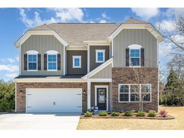 Charming two-story home featuring stone accents, a two-car garage, and a well-maintained lawn at 2248 Killian Creek Dr, Denver, NC 28037