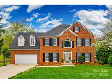 Beautiful two-story brick home featuring a manicured lawn, attached garage, and classic black shutters at 2515 Barrington Ct, Rock Hill, SC 29732