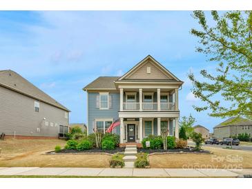 Charming two-story home featuring a welcoming front porch and well-maintained landscaping at 3013 Kensley Dr, Waxhaw, NC 28173