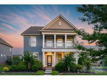 Charming two-story home boasts a welcoming porch and manicured lawn, perfect for suburban living at 3013 Kensley Dr, Waxhaw, NC 28173