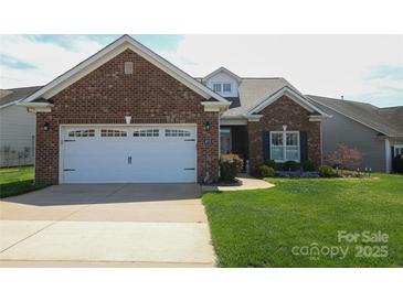 Charming single-story brick home featuring an attached two-car garage and well-maintained lawn at 403 Garner Dr, Salisbury, NC 28146