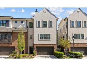 Charming townhome showcasing a modern architectural design, beautiful landscaping, and an attached two-car garage at 4038 City Homes Pl, Charlotte, NC 28209
