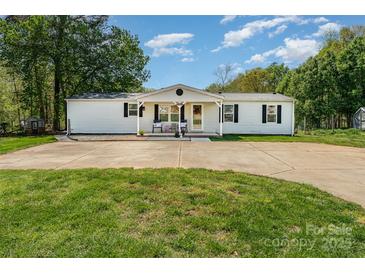 Charming home featuring a well-maintained front yard, white siding, and a cozy covered porch at 4767 Stratford Ln, Denver, NC 28037