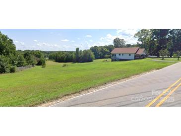 Charming single-story home with a spacious yard and covered porch, perfect for enjoying the outdoors at 6309 New Town Rd, Waxhaw, NC 28173