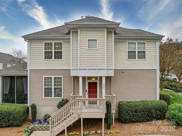 Charming two-story townhome featuring a red door, well-maintained landscaping, and a welcoming entryway at 920 Ashworth Dr, Gastonia, NC 28054